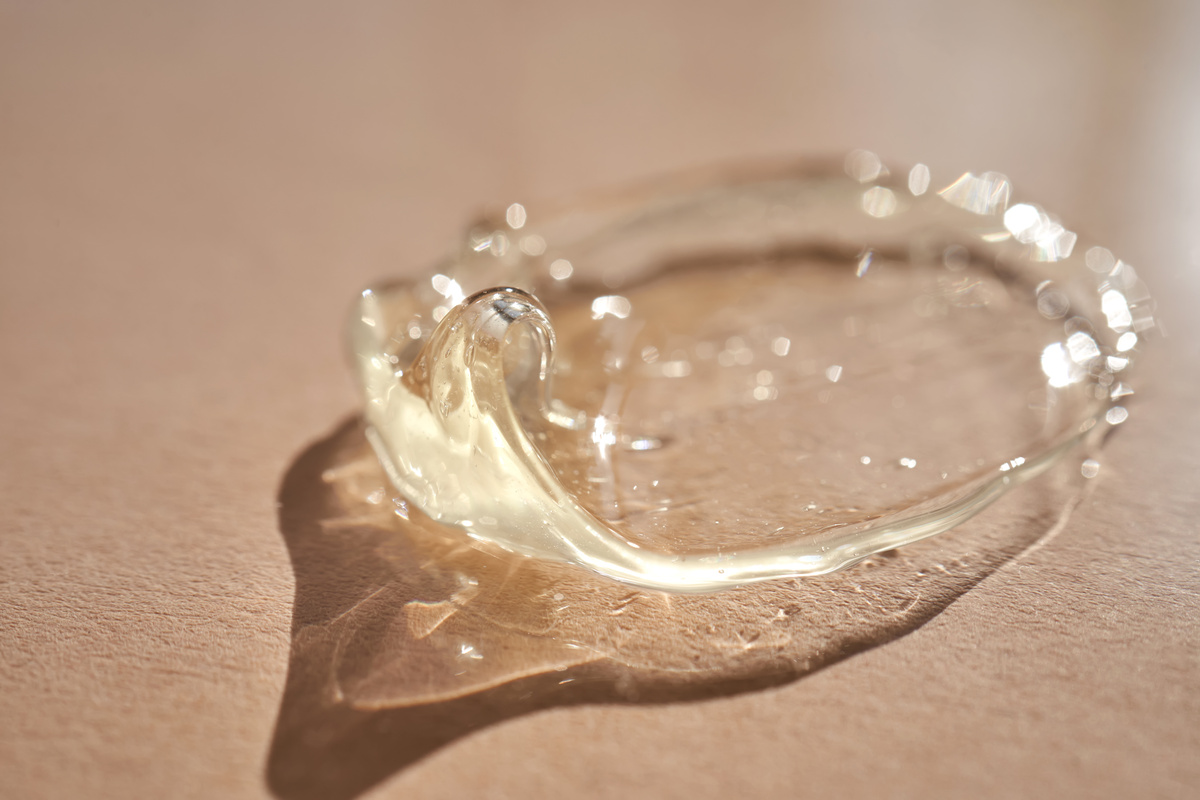 The texture of a yellow transparent gel cosmetic.